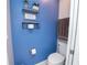 Stylish half bathroom with blue wall, decorative shelves, and modern fixtures at 5029 Walker St, St Cloud, FL 34771