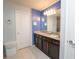 Bathroom featuring double sinks, granite countertops, and stylish fixtures at 5029 Walker St, St Cloud, FL 34771