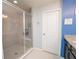 Bathroom featuring a glass-enclosed shower, white door, and granite countertop at 5029 Walker St, St Cloud, FL 34771