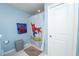Bathroom featuring a Spiderman themed shower curtain, matching hand towel, and neutral tiled floors at 5029 Walker St, St Cloud, FL 34771