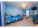 bedroom featuring playful decor, blue walls, ceiling fan, and ample space for toys at 5029 Walker St, St Cloud, FL 34771