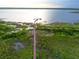 Aerial view of a long wooden dock extending into a tranquil lake surrounded by lush greenery and vegetation at 5029 Walker St, St Cloud, FL 34771