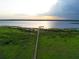Aerial view of a dock stretching into a serene lake with green vegetation in a natural and peaceful setting at 5029 Walker St, St Cloud, FL 34771