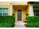 Home entrance with a tidy landscaped yard and dark gray door at 5029 Walker St, St Cloud, FL 34771