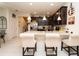 Open kitchen with stainless steel appliances, dark cabinets, and stone countertops at 5029 Walker St, St Cloud, FL 34771