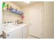 Functional laundry room with washer, dryer, shelving, and ample storage space at 5029 Walker St, St Cloud, FL 34771