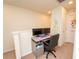 Cozy office nook features a desk, two monitors, an office chair, and a decorative art piece on the wall at 5029 Walker St, St Cloud, FL 34771