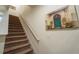 Carpeted staircase with white railing leads to the upper level at 5029 Walker St, St Cloud, FL 34771