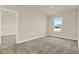 Cozy bedroom with carpet, neutral walls, and a view from the bright window at 5099 Marshelder St, Apopka, FL 32712