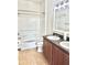 Bathroom featuring double sinks, wood-look cabinets, and a shower-tub combination at 535 Aeolian Dr, New Smyrna Beach, FL 32168
