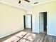 Spacious bedroom with wood-look floors and multiple doorways at 535 Aeolian Dr, New Smyrna Beach, FL 32168