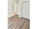Bedroom with wood-look flooring and a double closet, offering ample storage space at 535 Aeolian Dr, New Smyrna Beach, FL 32168