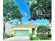 Charming single-story home featuring a green garage door, landscaped yard, and inviting front entrance at 535 Aeolian Dr, New Smyrna Beach, FL 32168