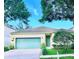 Charming single-story home featuring a green garage door, landscaped yard, and inviting front entrance at 535 Aeolian Dr, New Smyrna Beach, FL 32168