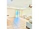 Bright living room featuring neutral decor, tile flooring, and sliding glass doors leading to the outdoors at 535 Aeolian Dr, New Smyrna Beach, FL 32168