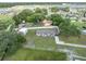 Aerial view of the home with large lawn and various outbuildings within a fenced perimeter at 5984 Ed Harris Ct, St Cloud, FL 34771