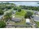Aerial view of the property featuring mature trees, and an expansive lawn at 5984 Ed Harris Ct, St Cloud, FL 34771