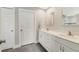 Bright bathroom featuring double sinks with white cabinets and modern fixtures at 5984 Ed Harris Ct, St Cloud, FL 34771