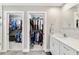 Bathroom featuring double closets, vanity with white cabinets, and marble countertops at 5984 Ed Harris Ct, St Cloud, FL 34771
