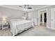 Bright, carpeted bedroom with a ceiling fan, closet and an adjacent walk-in closet at 5984 Ed Harris Ct, St Cloud, FL 34771