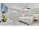 Serene bedroom with neutral tones, soft carpet, ceiling fan, and plenty of natural light at 5984 Ed Harris Ct, St Cloud, FL 34771