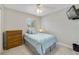 Cozy bedroom with a ceiling fan, dresser, and plush carpeting at 5984 Ed Harris Ct, St Cloud, FL 34771