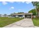 Charming single story home with a well manicured lawn, walkway and an adjacent outbuilding at 5984 Ed Harris Ct, St Cloud, FL 34771