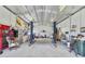 Interior view of a large garage featuring car lifts and a workbench along the back wall at 5984 Ed Harris Ct, St Cloud, FL 34771