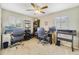Home office featuring a ceiling fan, two desks, and natural light from two windows at 5984 Ed Harris Ct, St Cloud, FL 34771