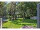 Expansive backyard with mature trees, playground, trampoline, and lake views, all fully fenced at 672 Seven Oaks Blvd, Winter Springs, FL 32708