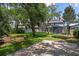 Spacious backyard featuring lush greenery, a play area, and a trampoline, perfect for outdoor activities at 672 Seven Oaks Blvd, Winter Springs, FL 32708