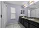 Bathroom featuring double sinks with granite countertops and a large mirror at 672 Seven Oaks Blvd, Winter Springs, FL 32708