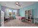 Bright, colorful bedroom with a desk, bookshelves and plenty of natural light at 672 Seven Oaks Blvd, Winter Springs, FL 32708