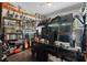 Eclectic bedroom featuring a ceiling fan, wood floors, and shelves stocked with various figurines and other interesting items at 672 Seven Oaks Blvd, Winter Springs, FL 32708