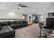 Upstairs bedroom with a couch, ceiling fan, and a play area with a slide and basketball hoop at 672 Seven Oaks Blvd, Winter Springs, FL 32708