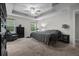 Bedroom featuring a ceiling fan, carpet, tray ceiling and furniture at 672 Seven Oaks Blvd, Winter Springs, FL 32708