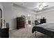 Bedroom featuring a ceiling fan, carpet, tray ceiling and furniture at 672 Seven Oaks Blvd, Winter Springs, FL 32708