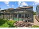 Exterior of home with a screened-in pool, covered lanai, and landscaped yard at 672 Seven Oaks Blvd, Winter Springs, FL 32708