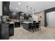 Modern kitchen with black cabinets, stainless steel appliances, and a center island with bar seating at 672 Seven Oaks Blvd, Winter Springs, FL 32708