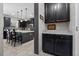 Modern kitchen with gray cabinets, an island with white countertop, and pendant lighting at 672 Seven Oaks Blvd, Winter Springs, FL 32708