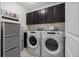 Well-organized laundry room with modern appliances, cabinetry, and storage solutions at 672 Seven Oaks Blvd, Winter Springs, FL 32708