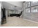 Spacious living room with tile floors, a staircase, and ample natural light, perfect for gatherings and relaxation at 672 Seven Oaks Blvd, Winter Springs, FL 32708