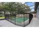 Screened in pool with a stacked stone water feature and mature landscaping in the fenced backyard at 672 Seven Oaks Blvd, Winter Springs, FL 32708