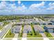 An aerial view of a neighborhood featuring well-maintained homes, green lawns, and neatly paved streets at 744 Curly Locks Loop, Apopka, FL 32703
