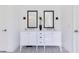 Bright bathroom with dual sinks, decorative tile flooring, and modern fixtures at 744 Curly Locks Loop, Apopka, FL 32703