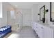 Bathroom with dual vanities, decorative tile flooring, and a glass-enclosed shower at 744 Curly Locks Loop, Apopka, FL 32703