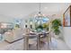 Elegant dining room with natural light and comfortable seating seamlessly connected to the living room with a TV at 744 Curly Locks Loop, Apopka, FL 32703