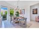 Elegant dining room featuring a round table, chandelier, and access to the outdoor area at 744 Curly Locks Loop, Apopka, FL 32703