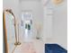 Bright entryway featuring a mirror, area rug, and a glimpse into other rooms of the home at 744 Curly Locks Loop, Apopka, FL 32703