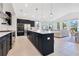 Modern kitchen with a large island, stainless steel appliances, and open floor plan at 744 Curly Locks Loop, Apopka, FL 32703